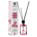 a bottle of pink fragrance with sticks