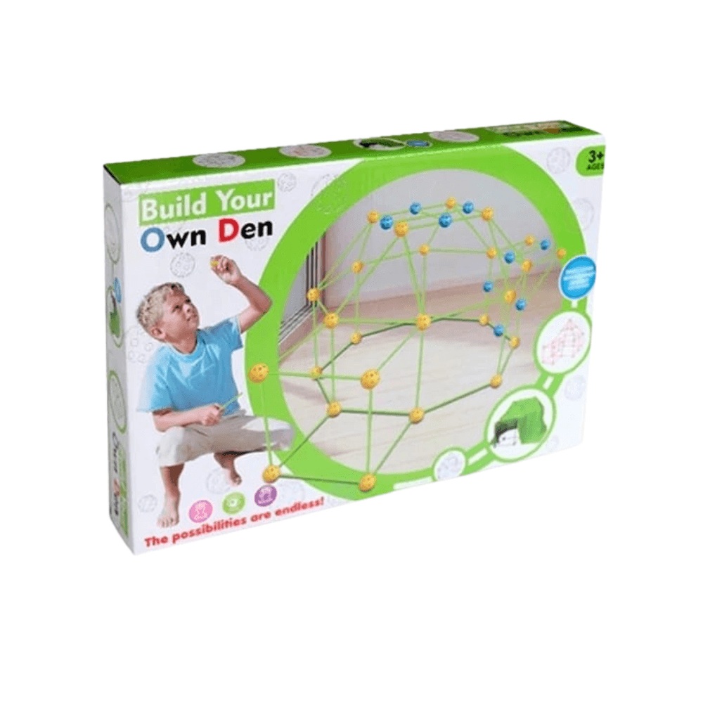 Gros plan sur la boîte d'un kit de construction pour enfants appelé "Build Your Own Den" (Construisez Votre Propre Cabane). La boîte montre un jeune garçon blond en train d'assembler une structure en forme de dôme à l'aide de tiges vertes et de connecteurs jaunes et bleus. L'inscription "3+ AGES" et "The possibilities are endless!" (Les possibilités sont infinies !) est visible.